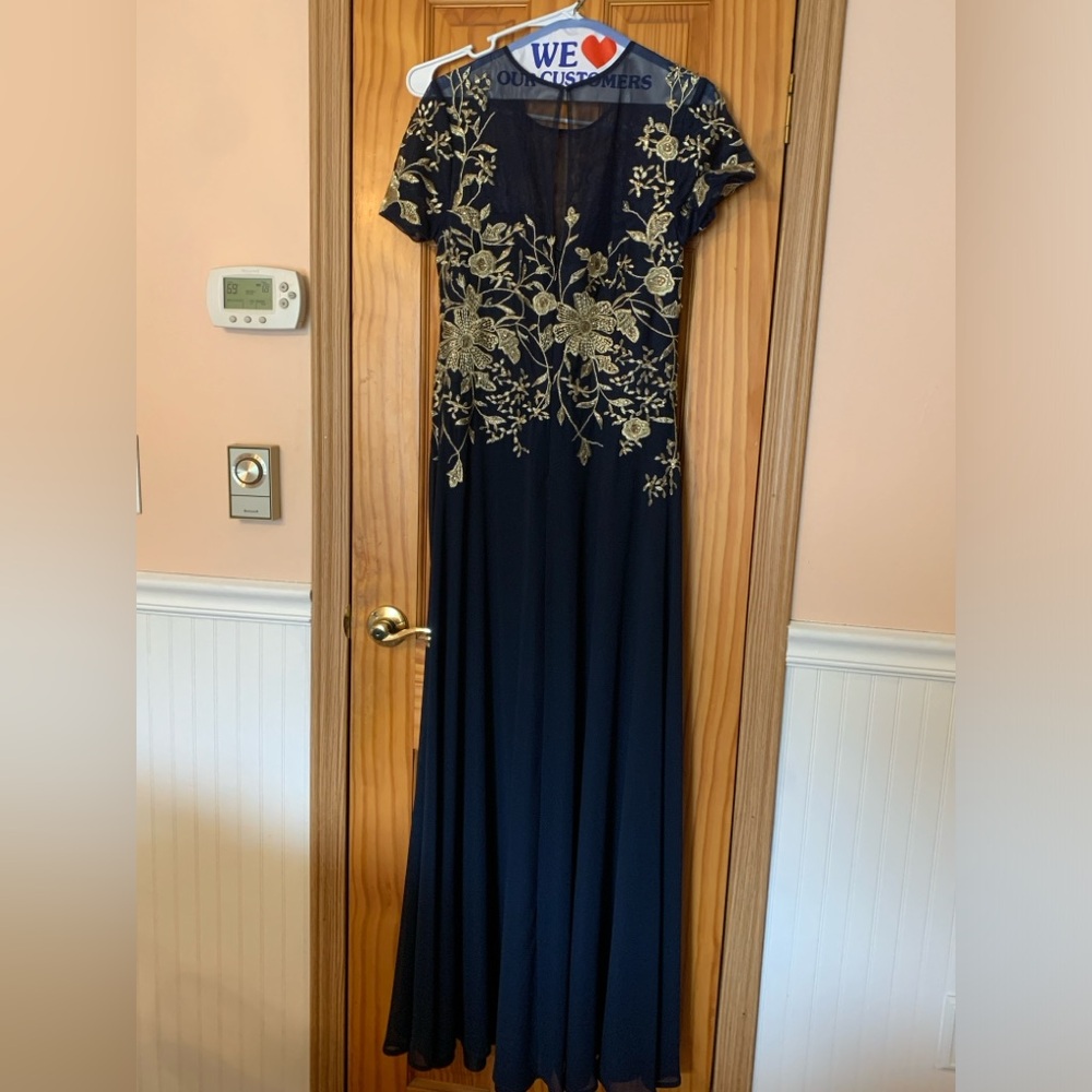Betsy & Adam gown  size14. Very comfortable.  Navy blue. Worn once cleaned